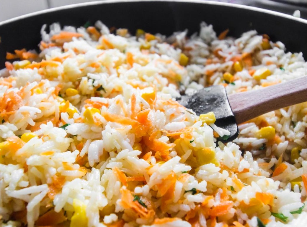 Thai fried rice with carrots and corn cooking in a pan